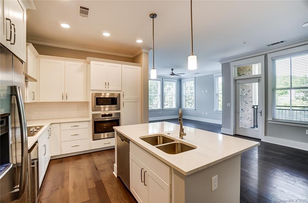 830 Providence Road, Unit 303 Charlotte, NC 28207 - Photo 9 of 39 a kitchen that has a sink a stove and a refrigerator