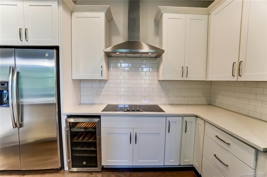 830 Providence Road, Unit 303 Charlotte, NC 28207 - Photo 10 of 39 a kitchen with granite countertop white cabinets and a stove