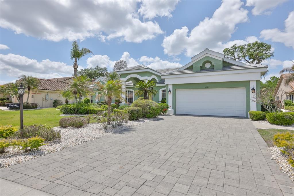 a front view of a house with a yard and outdoor seating