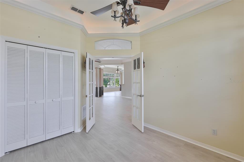 1107 Opal Lane Sun City Center, FL 33573 - Photo 14 of 72 a view of a hallway with a chandelier fan