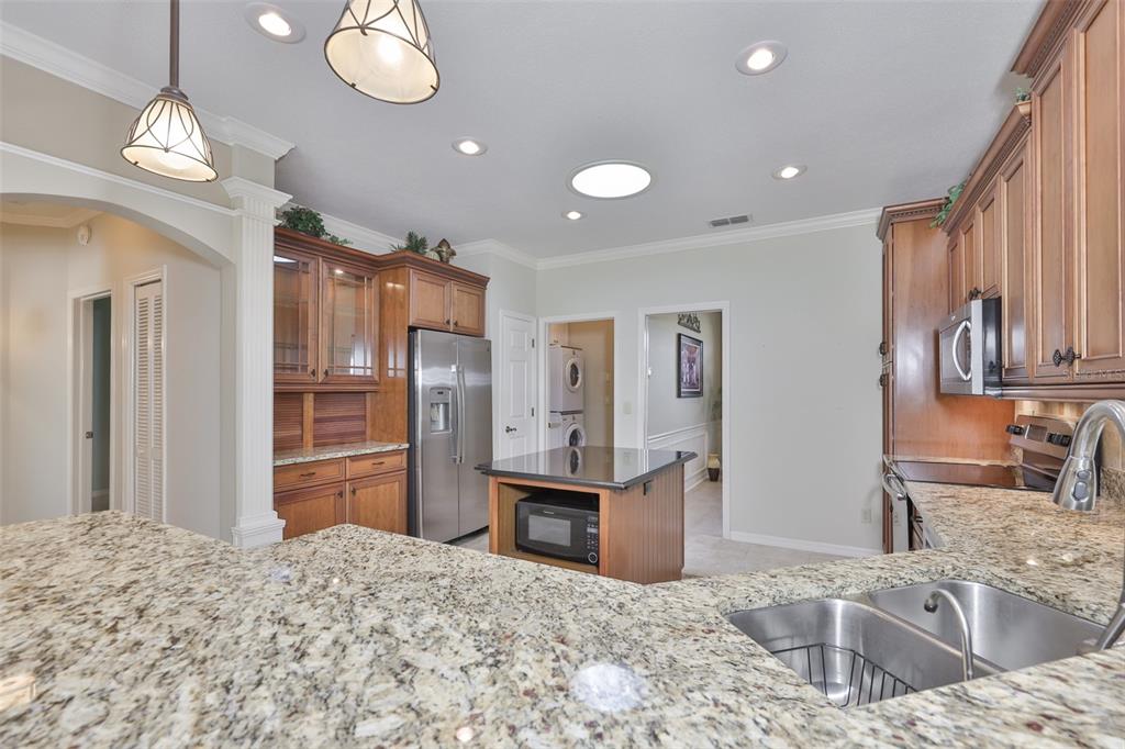 1107 Opal Lane Sun City Center, FL 33573 - Photo 17 of 72 a kitchen with granite countertop a refrigerator and a sink