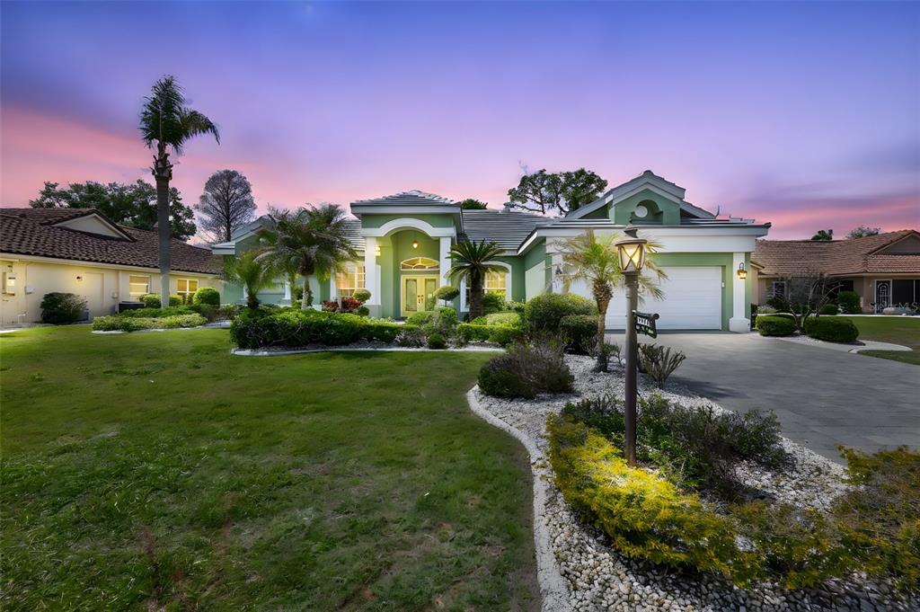 1107 Opal Lane Sun City Center, FL 33573 - Photo 2 of 72 a front view of a house with garden