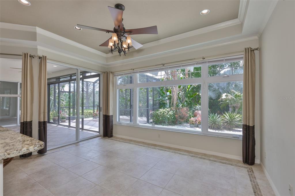 1107 Opal Lane Sun City Center, FL 33573 - Photo 21 of 72 a view of an empty room with wooden floor and a window