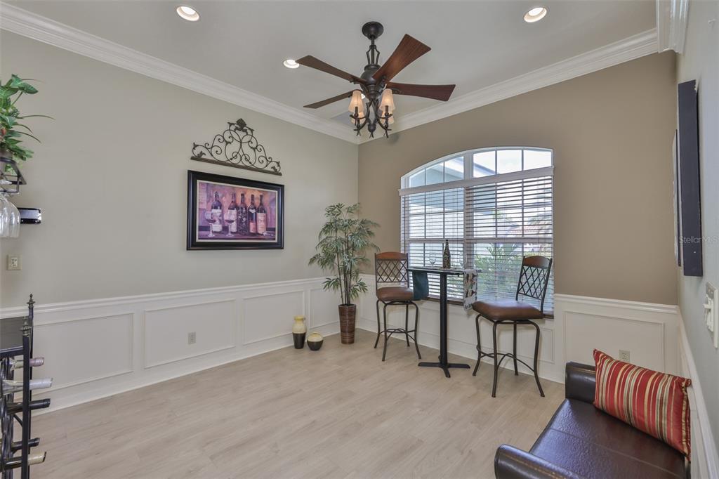 1107 Opal Lane Sun City Center, FL 33573 - Photo 24 of 72 a workspace with furniture a chandelier and a window