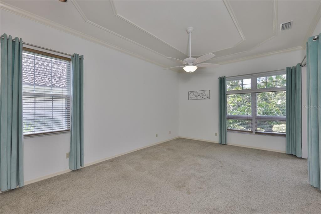 1107 Opal Lane Sun City Center, FL 33573 - Photo 28 of 72 an empty room with windows and fan