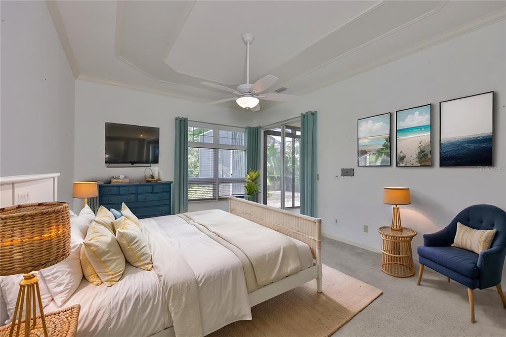 1107 Opal Lane Sun City Center, FL 33573 - Photo 29 of 72 a bedroom with a bed flat screen tv and windows