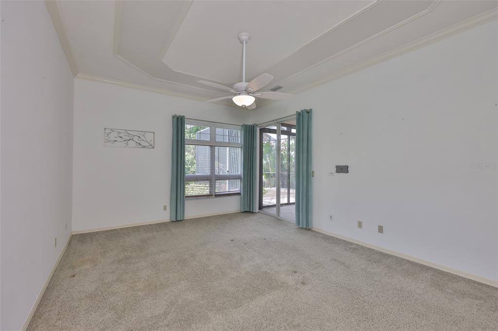 1107 Opal Lane Sun City Center, FL 33573 - Photo 30 of 72 an empty room with windows and ceiling fan