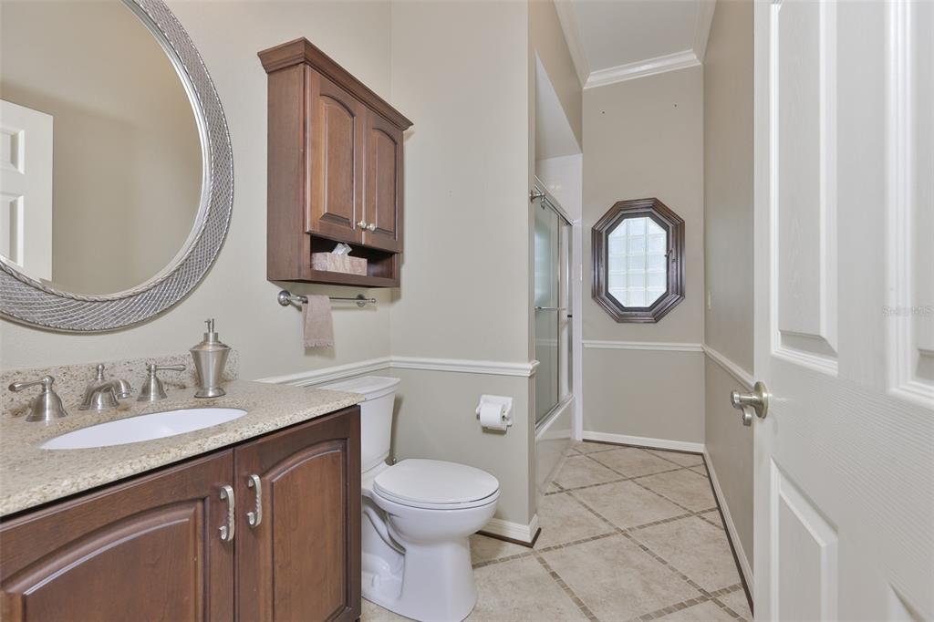 1107 Opal Lane Sun City Center, FL 33573 - Photo 37 of 72 a bathroom with a toilet a sink and mirror