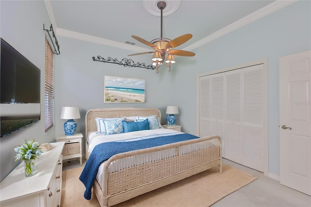 1107 Opal Lane Sun City Center, FL 33573 - Photo 39 of 72 a bedroom with a bed and a chandelier