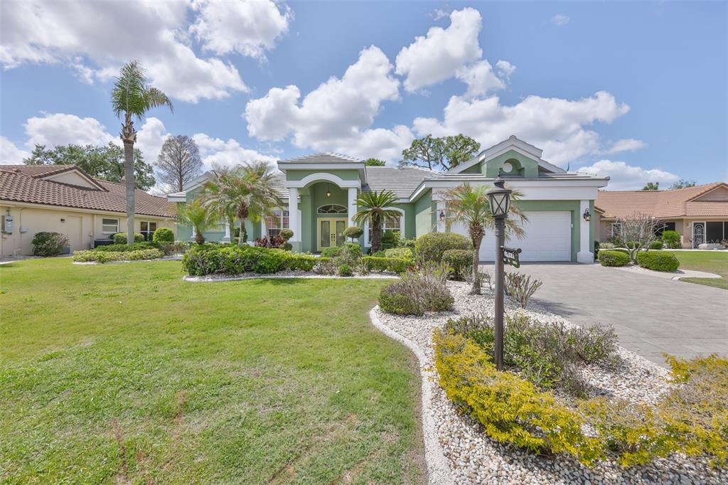 1107 Opal Lane Sun City Center, FL 33573 - Photo 4 of 72 a front view of house with yard and green space
