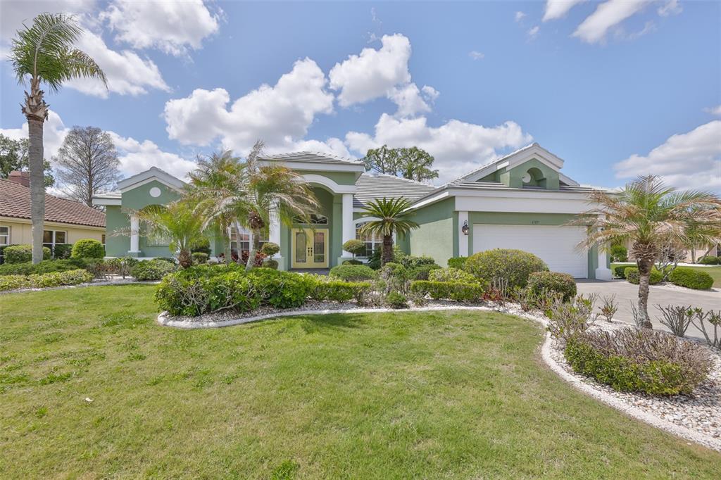 1107 Opal Lane Sun City Center, FL 33573 - Photo 5 of 72 a view of a house with a big yard and potted plants