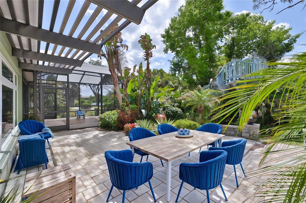 1107 Opal Lane Sun City Center, FL 33573 - Photo 52 of 72 a view of a backyard with table and chairs potted plants and large tree
