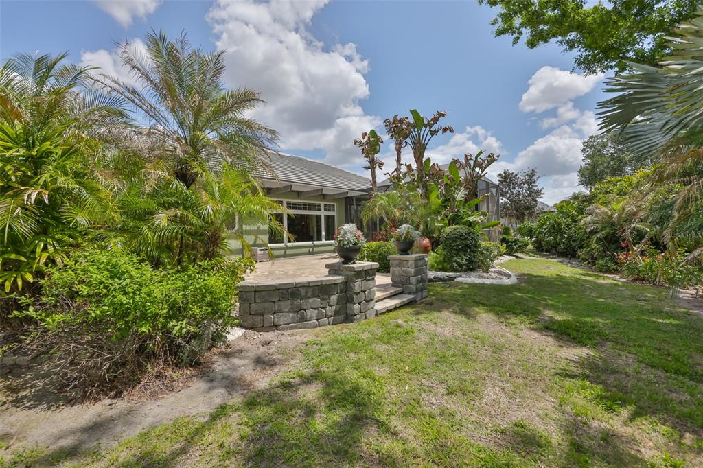 1107 Opal Lane Sun City Center, FL 33573 - Photo 55 of 72 a view of a backyard with plants and a garden