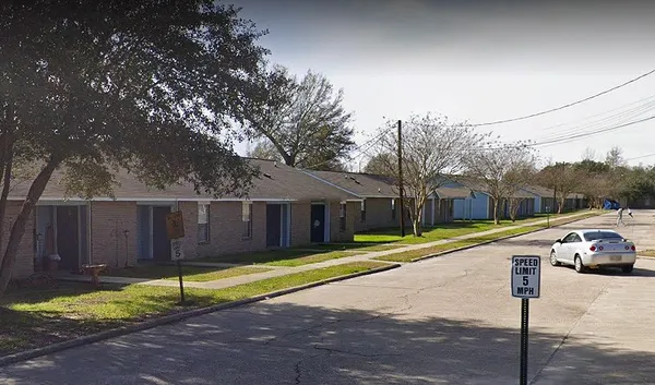 a view of a house with backyard and a tree