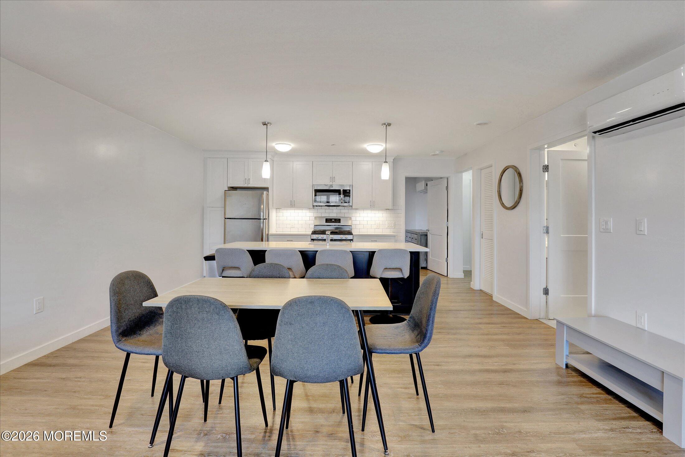 55 Brighton Avenue, Unit 2 Long Branch, NJ 07740 - Photo 13 of 36 a view of a dining room with furniture and wooden floor