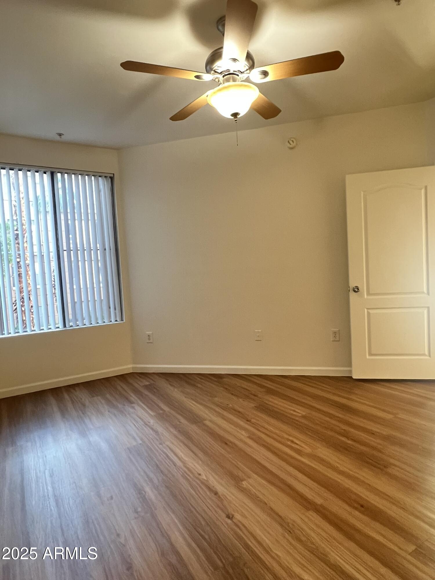 1701 East Colter Street, Unit 253 Phoenix, AZ 85016 - Photo 7 of 17 a view of an empty room with wooden floor