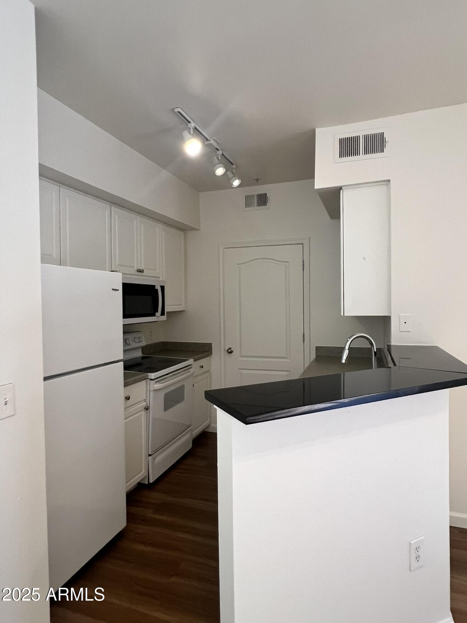 1701 East Colter Street, Unit 253 Phoenix, AZ 85016 - Photo 9 of 17 a kitchen with a sink a stove and refrigerator