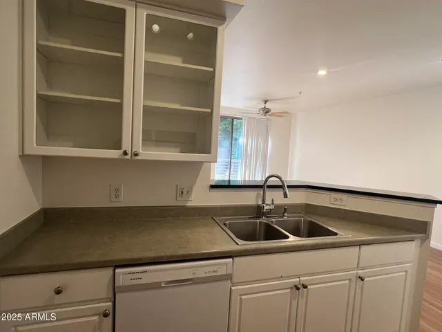 a kitchen with a sink and cabinets