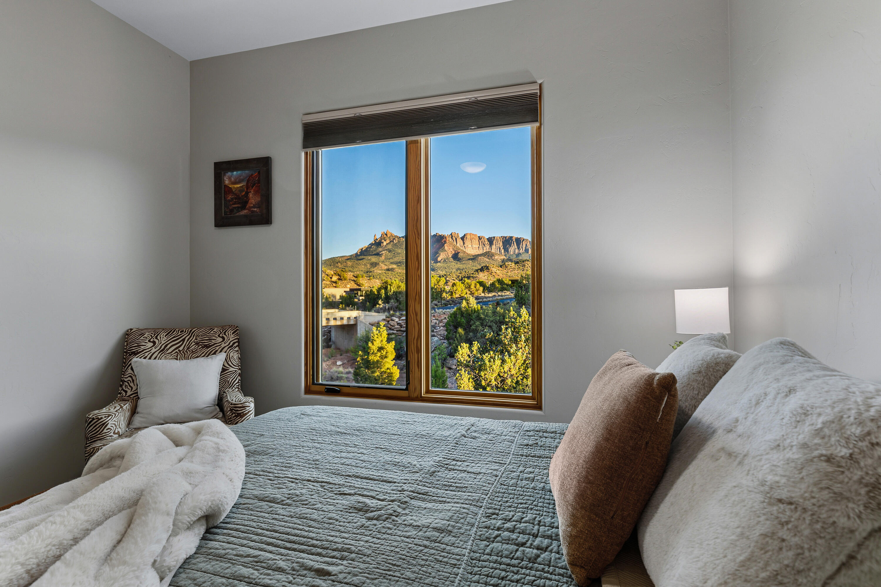 3000 Navajo Way Springdale, UT 84767 - Photo 28 of 63 Secondary bedroom with a window framing the surrounding red rock views.