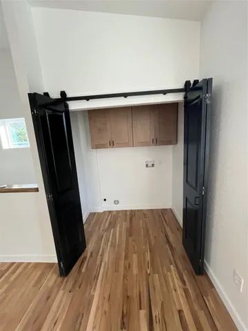 a view of closet with wooden floor