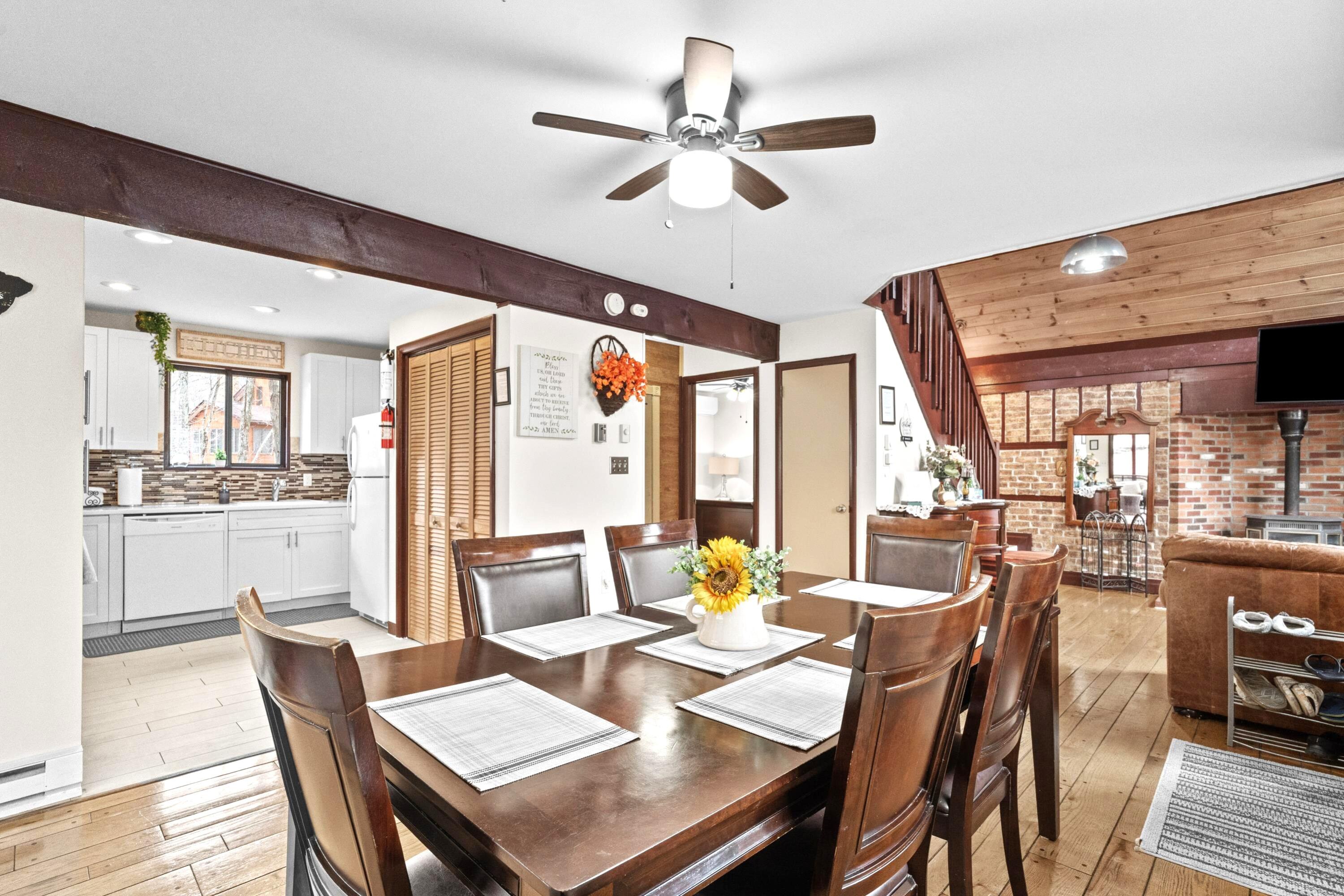 2196 Scarborough Way Bushkill, PA 18324 - Photo 11 of 58 a dining room with furniture a chandelier and wooden floor