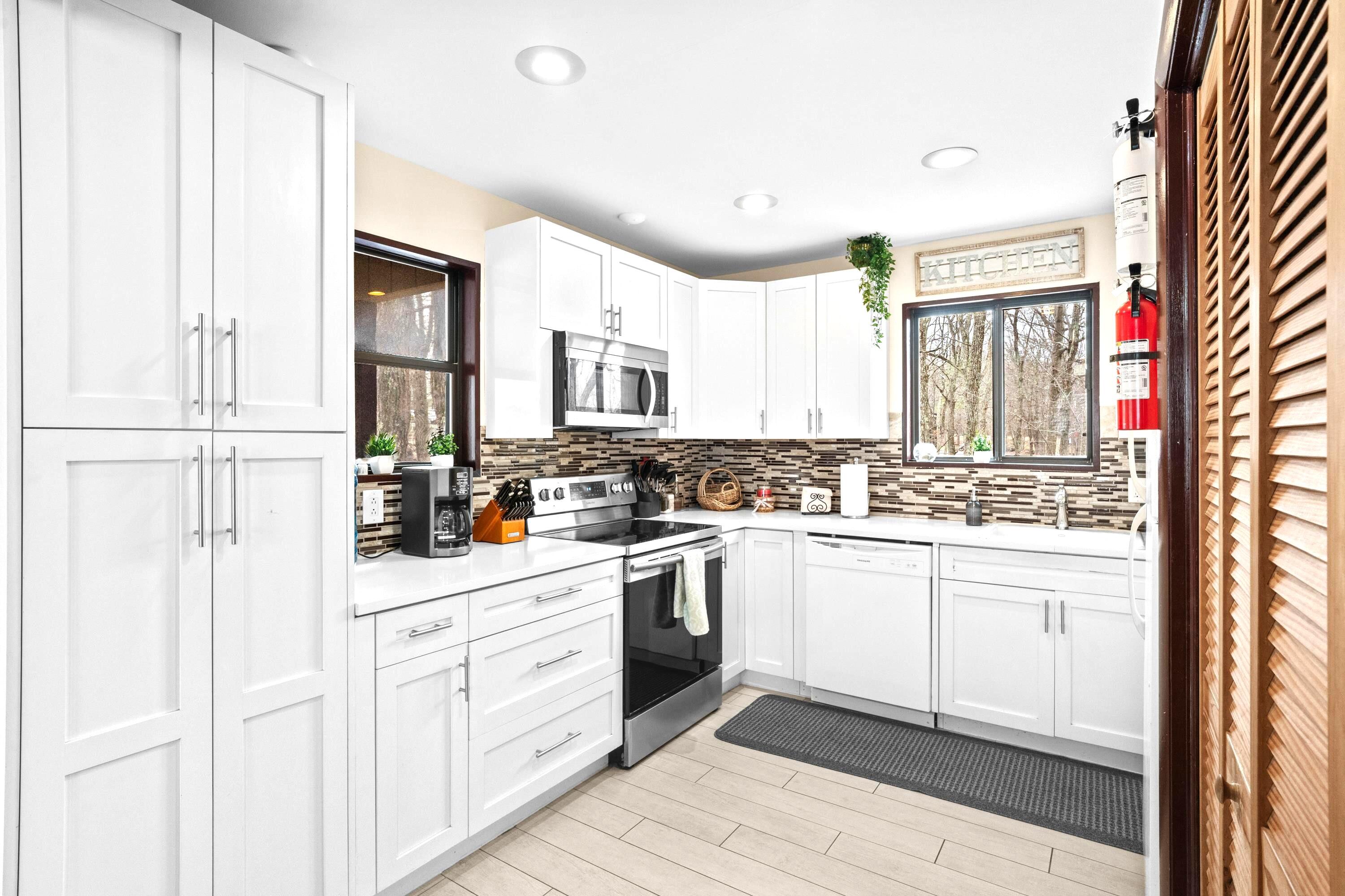 2196 Scarborough Way Bushkill, PA 18324 - Photo 13 of 58 a kitchen with white cabinets and white appliances