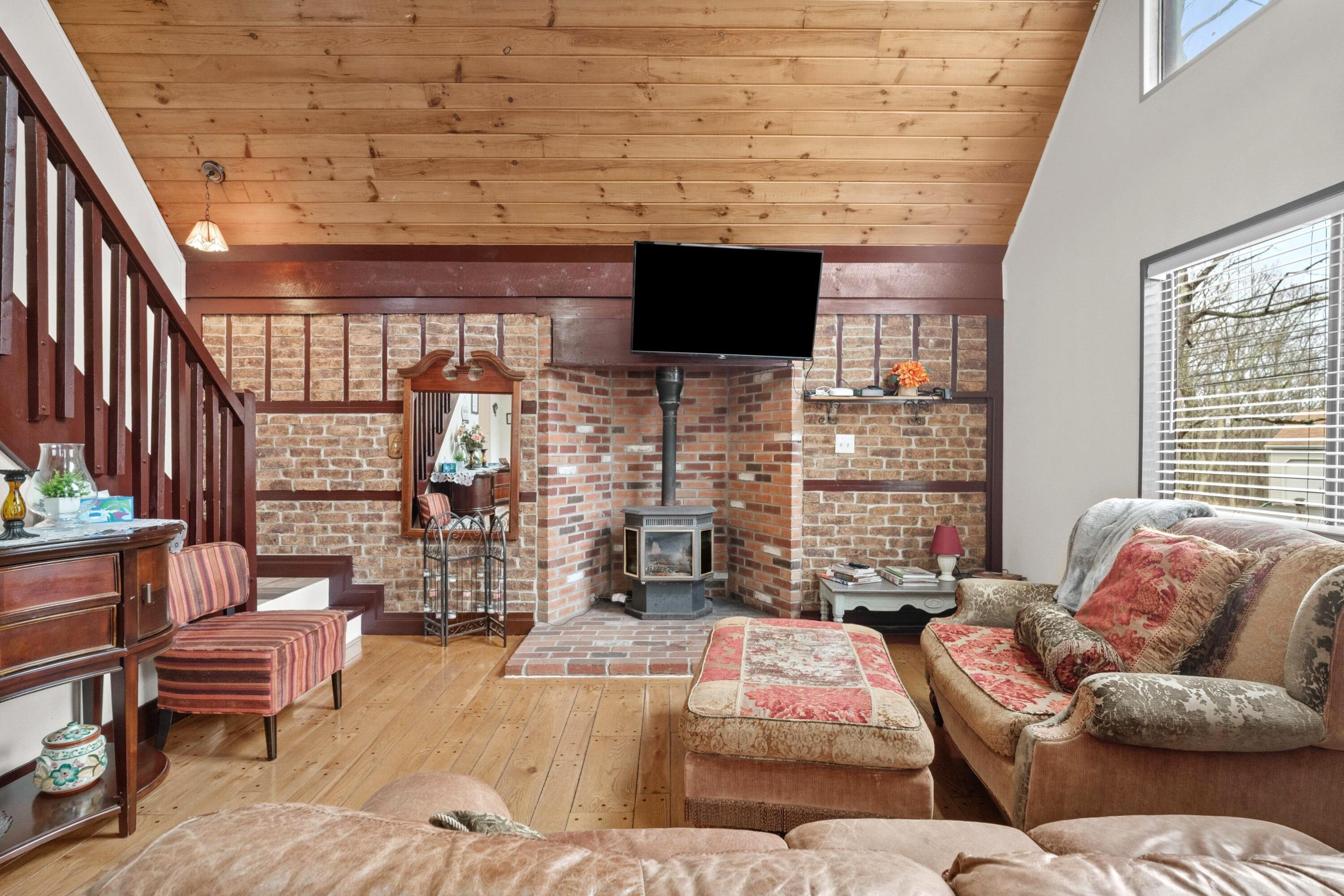 2196 Scarborough Way Bushkill, PA 18324 - Photo 17 of 58 a living room with furniture a flat screen tv and a fireplace