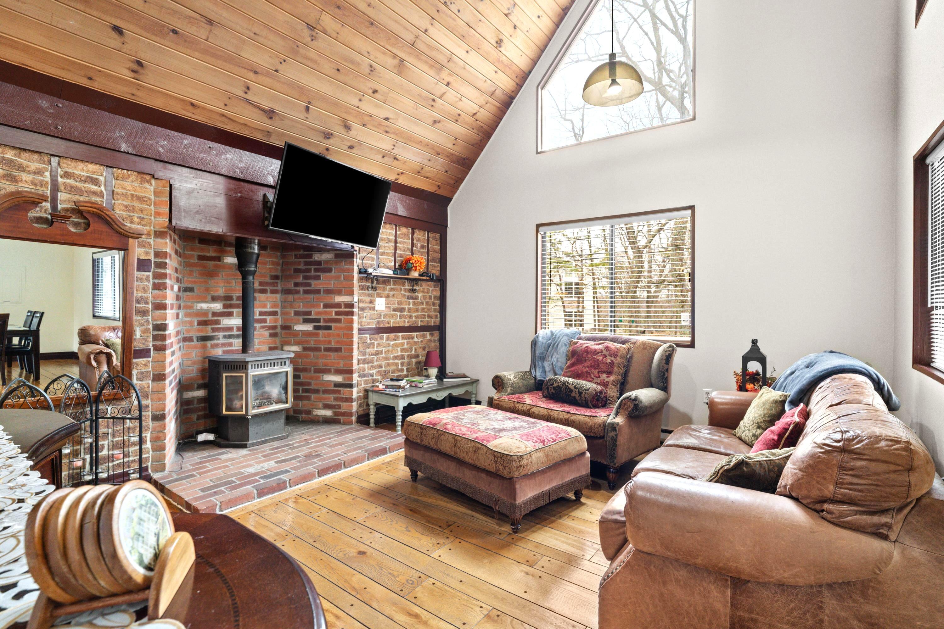 2196 Scarborough Way Bushkill, PA 18324 - Photo 2 of 58 a living room with furniture fireplace and flat screen tv