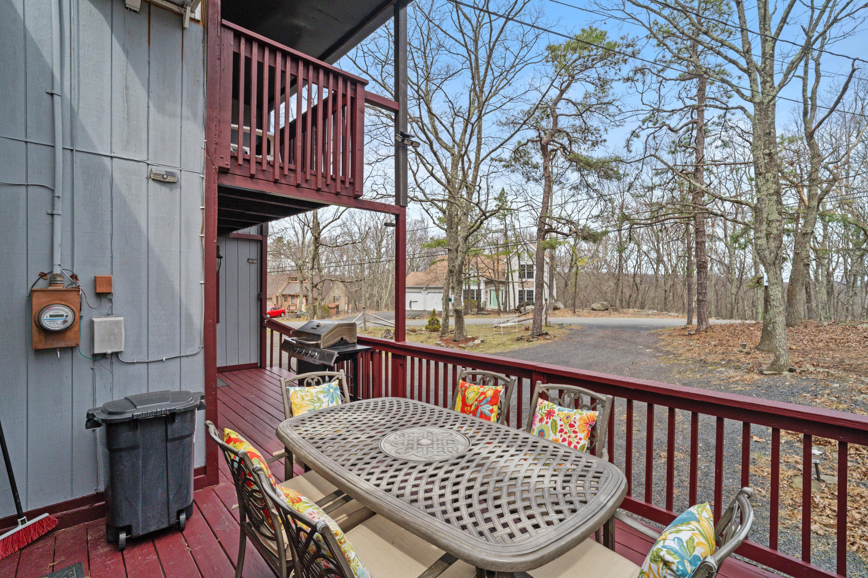 2196 Scarborough Way Bushkill, PA 18324 - Photo 26 of 58 a view of a roof deck with table and chairs a barbeque with wooden floor and fence