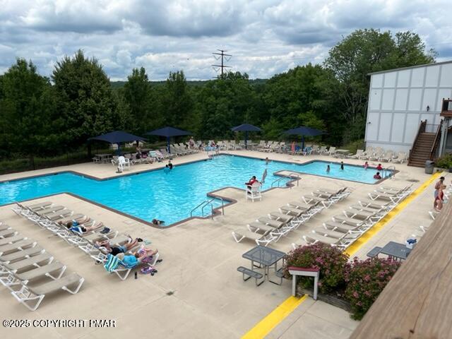 2196 Scarborough Way Bushkill, PA 18324 - Photo 30 of 58 a view of a swimming pool with a lounge chairs
