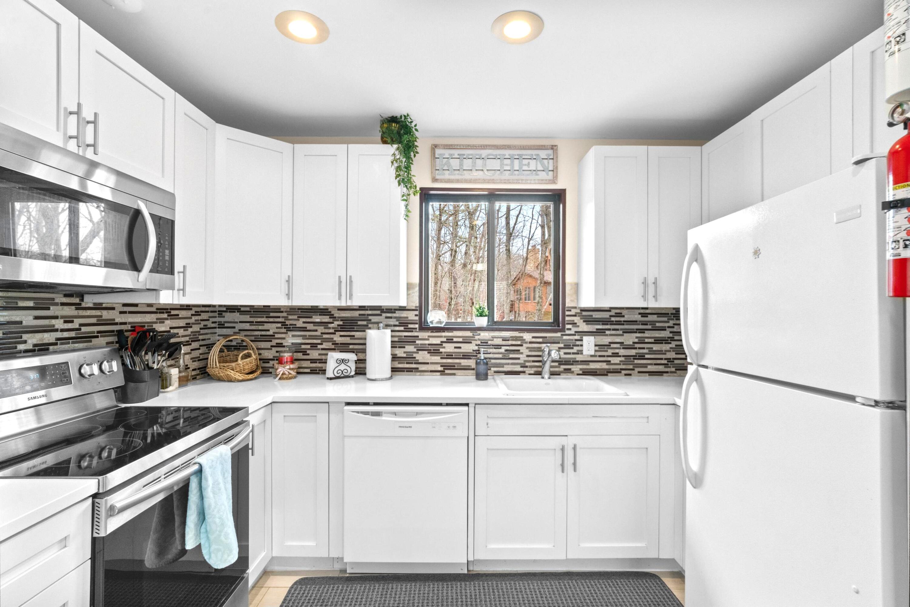 2196 Scarborough Way Bushkill, PA 18324 - Photo 3 of 58 a kitchen with white cabinets and white appliances