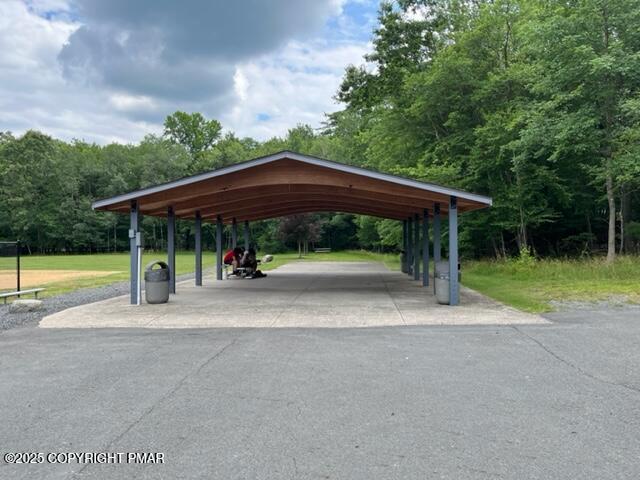 2196 Scarborough Way Bushkill, PA 18324 - Photo 48 of 58 a view of a patio with a table and chairs under an umbrella