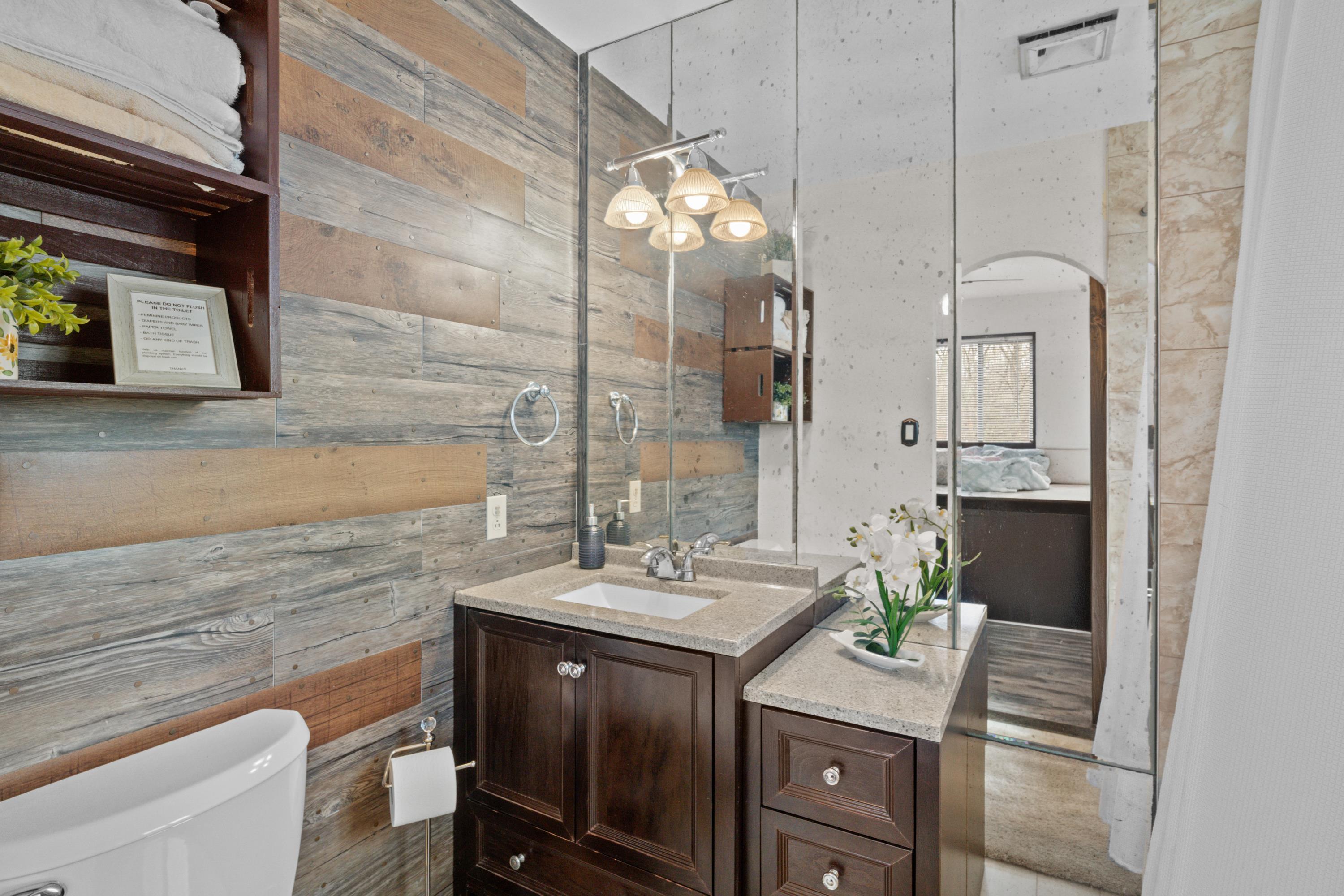 2196 Scarborough Way Bushkill, PA 18324 - Photo 6 of 58 a bathroom with a sink a toilet and mirror