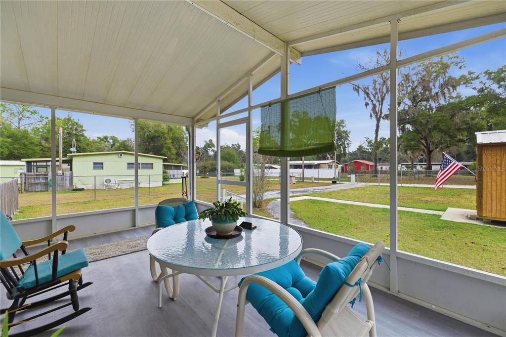 17172 Northeast 37th Terrace Citra, FL 32113 - Photo 24 of 38 a view of a swimming pool with a table and chairs in patio