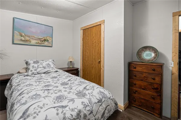 a bedroom with a bed and a dresser