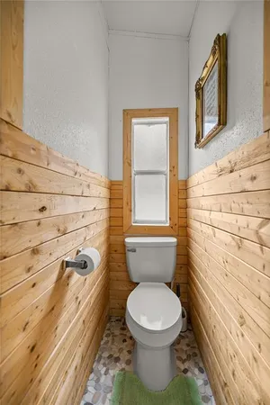 a bathroom with a toilet a sink and a window