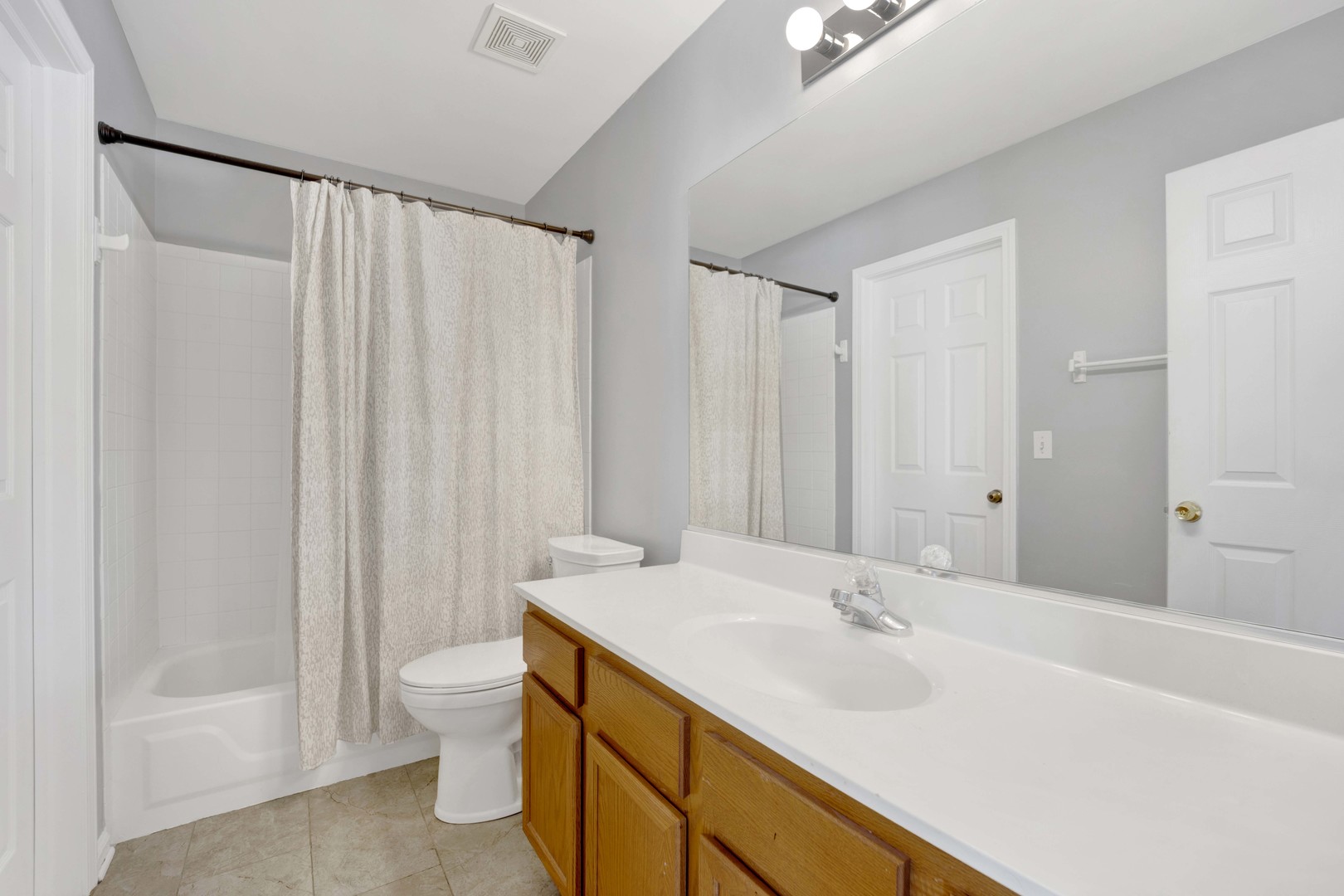 2571 Eldorado Lane, Unit 1 Naperville, IL 60564 - Photo 17 of 21 a bathroom with a sink a toilet and a large mirror
