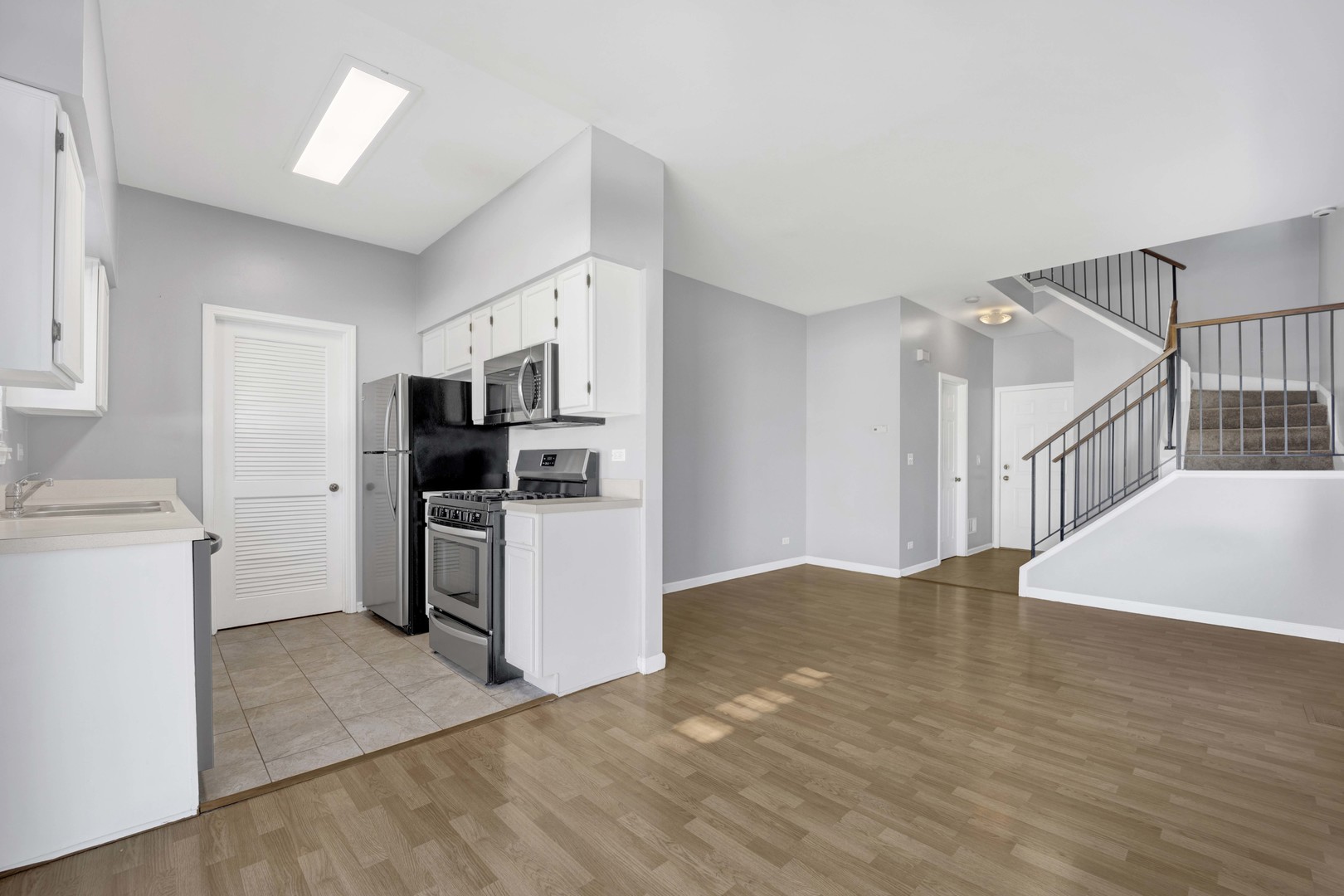 2571 Eldorado Lane, Unit 1 Naperville, IL 60564 - Photo 4 of 21 a kitchen with stainless steel appliances kitchen island a refrigerator sink and cabinets