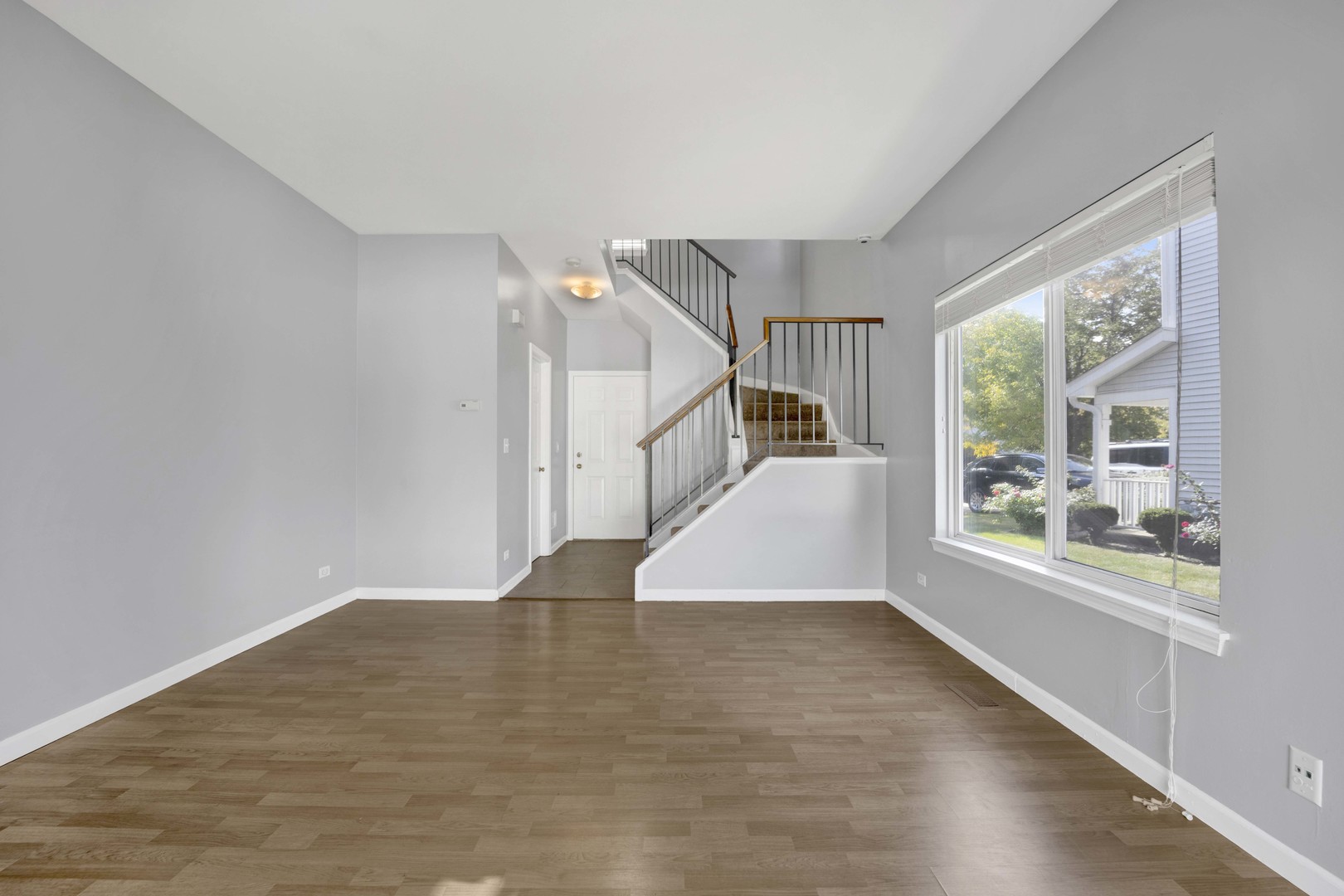 2571 Eldorado Lane, Unit 1 Naperville, IL 60564 - Photo 5 of 21 a view of empty room with wooden floor and fan