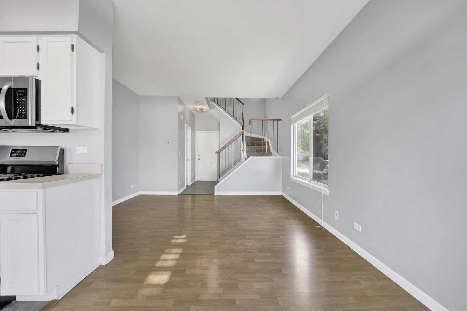 2571 Eldorado Lane, Unit 1 Naperville, IL 60564 - Photo 6 of 21 a view of empty room with wooden floor and fan