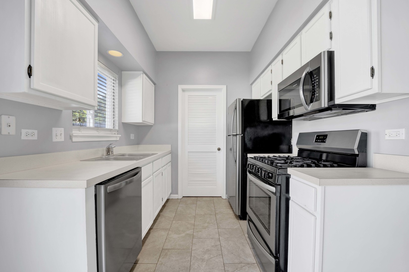 2571 Eldorado Lane, Unit 1 Naperville, IL 60564 - Photo 7 of 21 a kitchen with stainless steel appliances granite countertop a stove top oven a sink a refrigerator and white cabinets