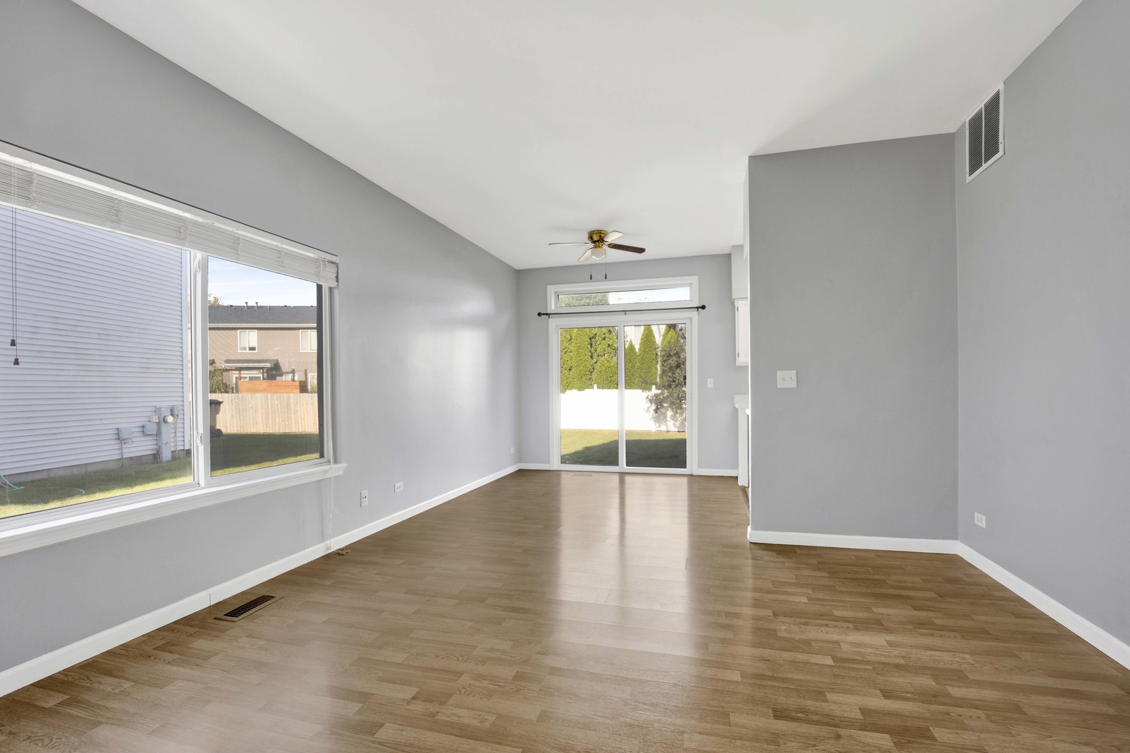 2571 Eldorado Lane, Unit 1 Naperville, IL 60564 - Photo 10 of 21 a view of an empty room with wooden floor and a window