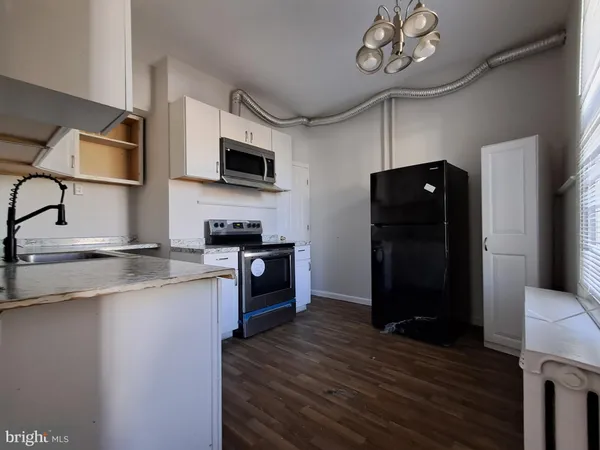 a kitchen with stainless steel appliances granite countertop a sink and a microwave
