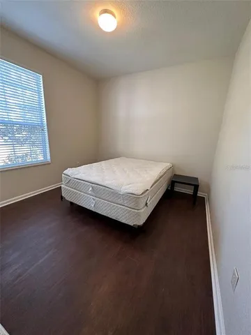 a room with a bed and window
