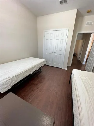 a bed sitting in a bedroom next to a window