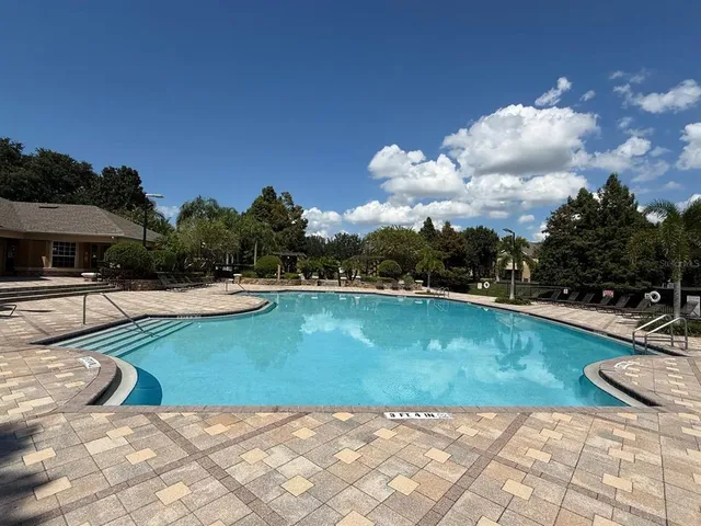 a view of a swimming pool and lounge chairs