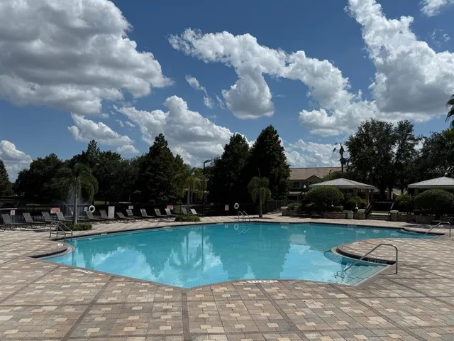 a view of a swimming pool with outdoor seating