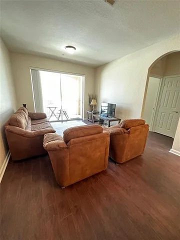 a living room with furniture window and a wooden floor