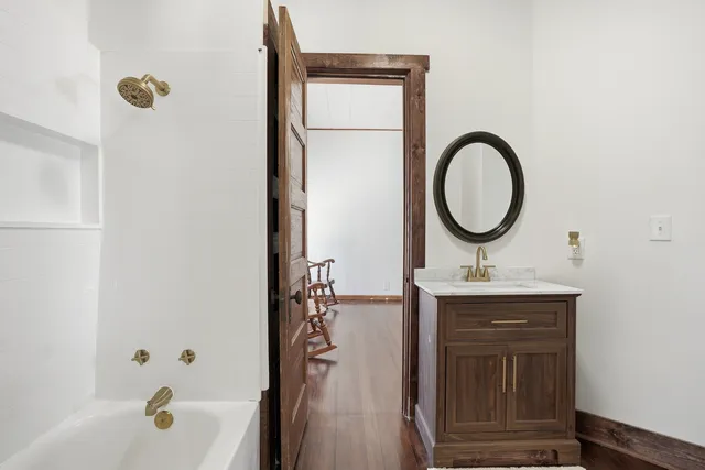 a bathroom with a sink a toilet and a mirror