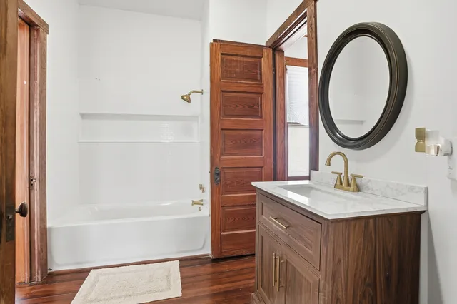 a bathroom with a sink a vanity and a mirror